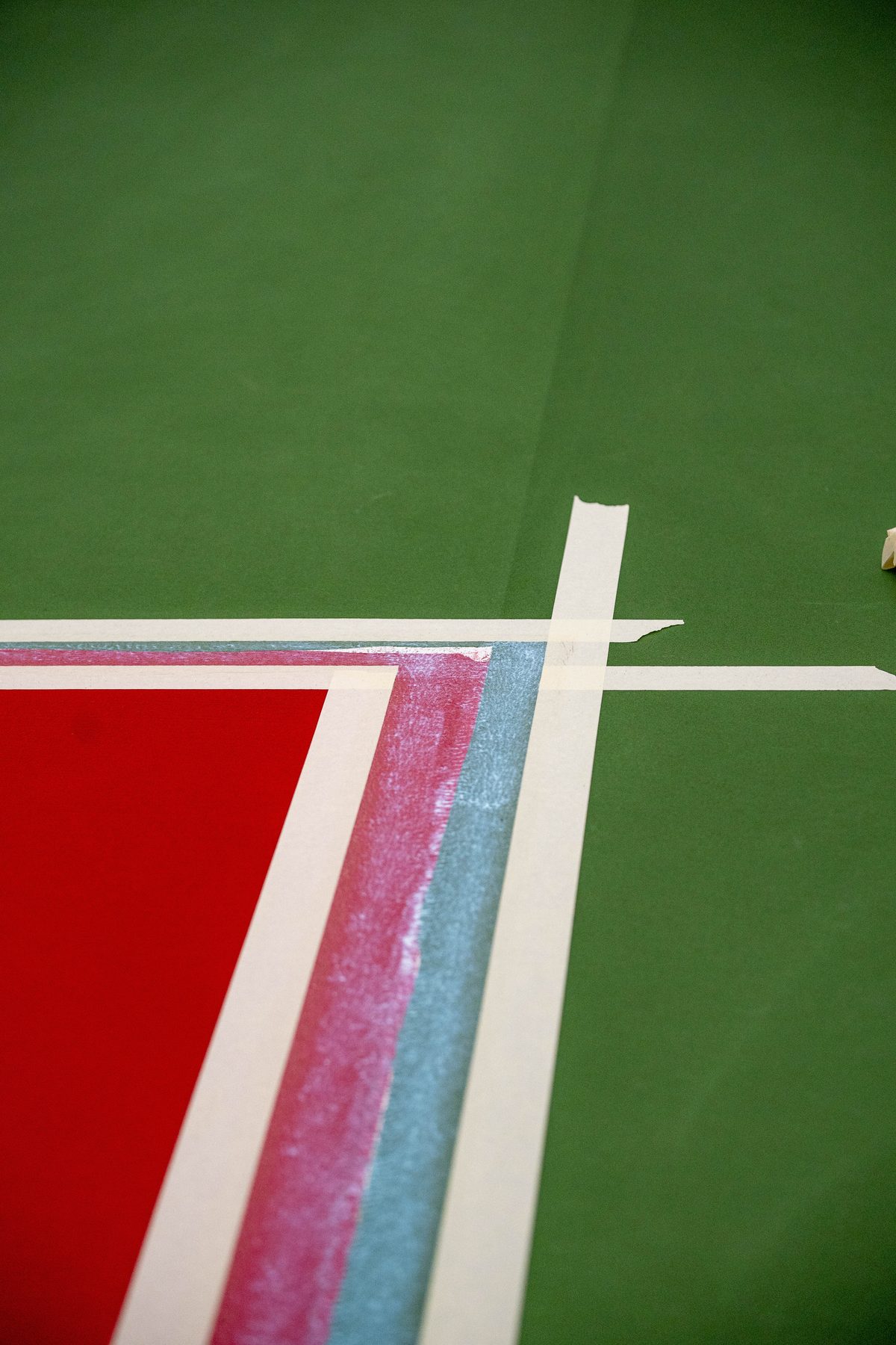 Close-up of a fresh white line over red and green Laykold at OU