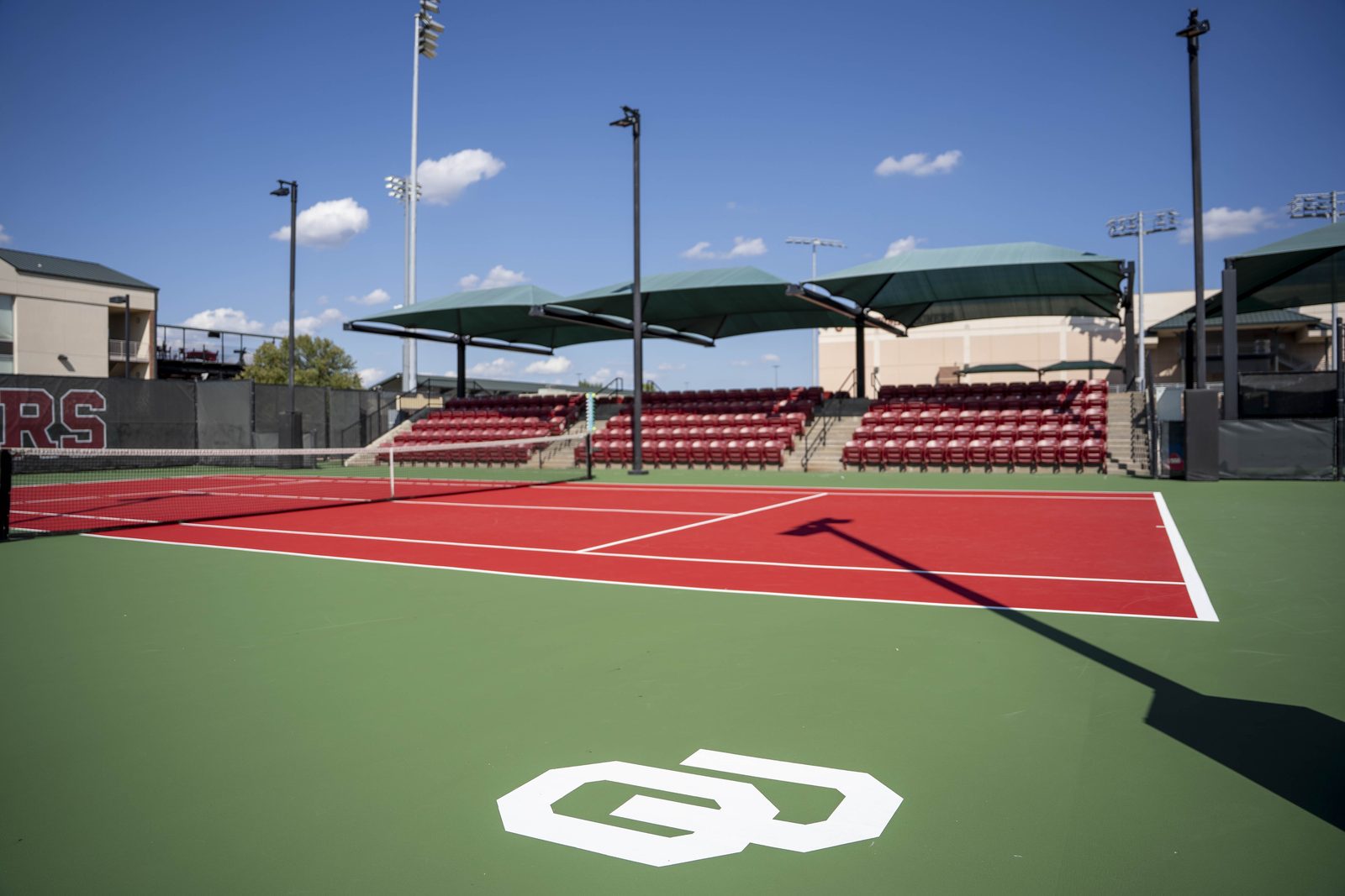 OU logo stenciled on green court surround