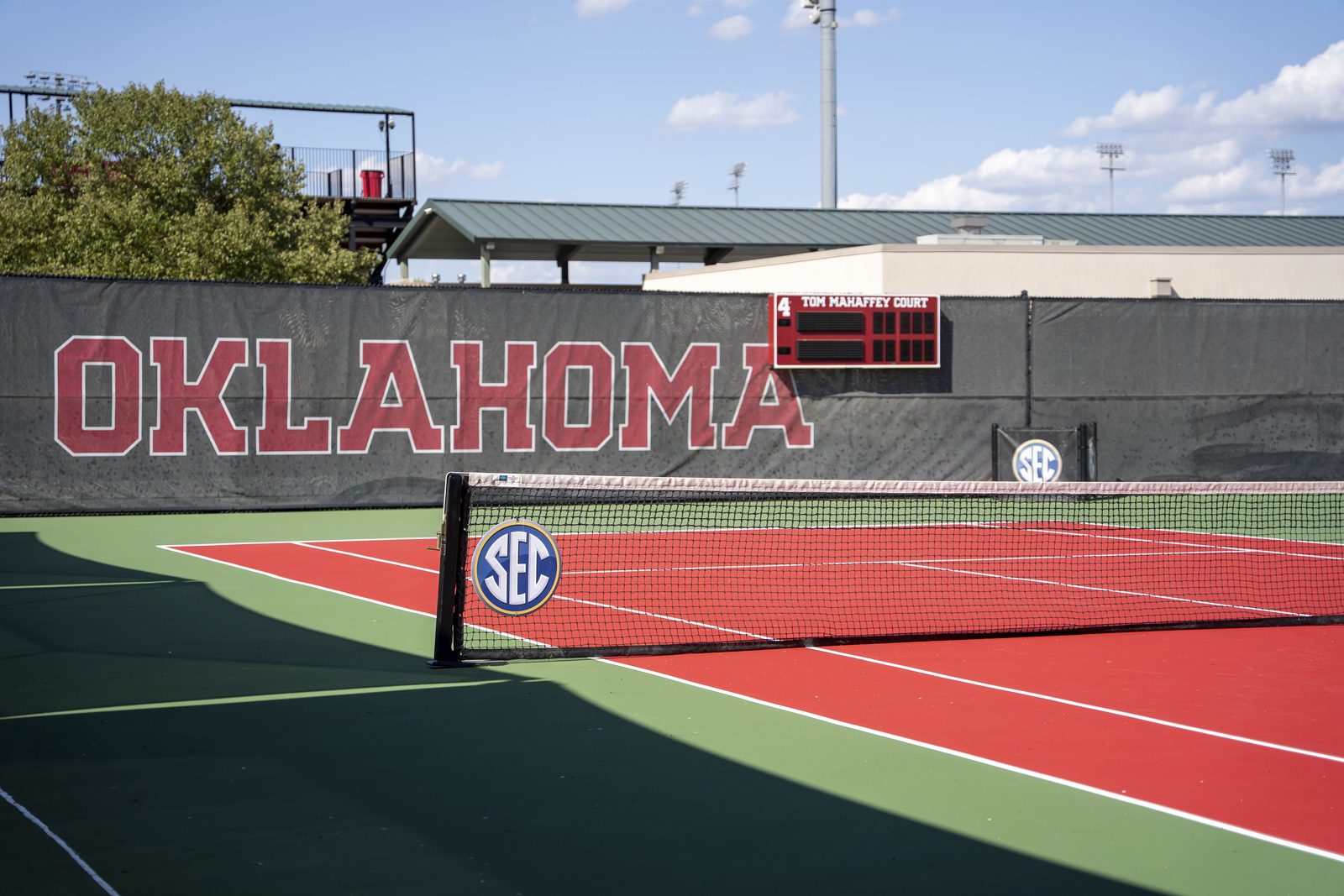 Red and green Laykold tennis court with the Oklahoma wall and SEC net at Headington Tennis Center